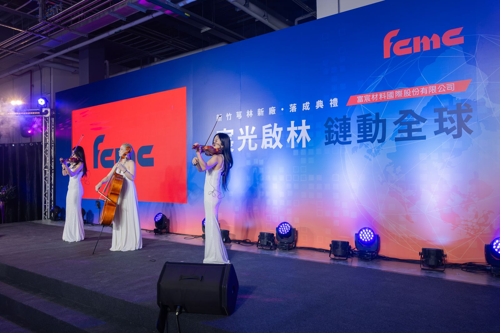 A string trio performing on the ceremony stage
